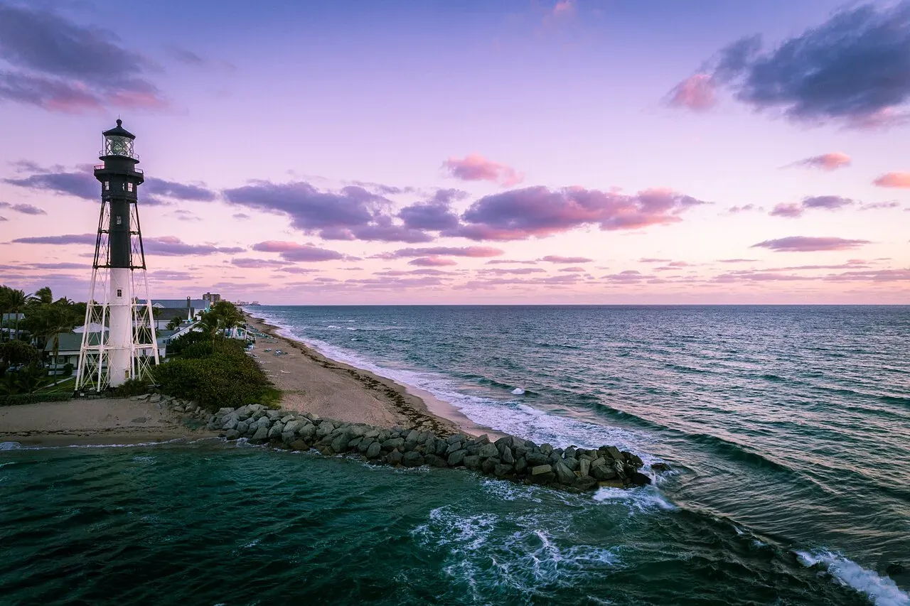 Hillsboro Inlet Lighthouse over beach and surf at dusk, Hillsboro Beach