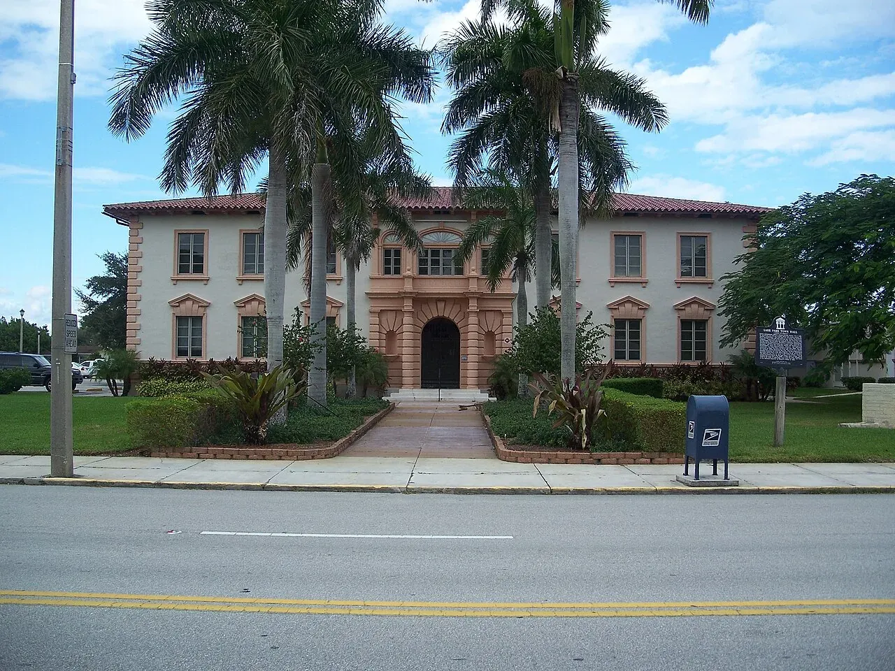 Historic Kelsey City Town Hall with royal palms, Lake Park, Lake Park